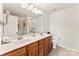 Bathroom with double vanity sinks, a large mirror, and tile flooring at 12124 Red Rust Ln, Charlotte, NC 28277