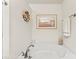 Bathroom features a soaking tub, seashell decor, and beach-themed art at 12124 Red Rust Ln, Charlotte, NC 28277