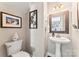 Charming half bathroom with pedestal sink and stylish wall decor at 12124 Red Rust Ln, Charlotte, NC 28277