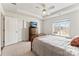 Bright bedroom features a ceiling fan, tray ceiling, and a large window with natural light at 12124 Red Rust Ln, Charlotte, NC 28277