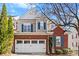 Charming brick and siding exterior with a two-car garage and blue shutters at 12124 Red Rust Ln, Charlotte, NC 28277