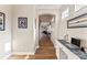 Bright hallway with wood floors, staircase, and open view to living area with fireplace at 12124 Red Rust Ln, Charlotte, NC 28277