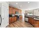 Well-lit kitchen features stainless steel appliances, dark countertops, and wood cabinets at 12124 Red Rust Ln, Charlotte, NC 28277