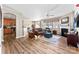 Spacious living room with hardwood floors, fireplace, and seamless flow to kitchen at 12124 Red Rust Ln, Charlotte, NC 28277