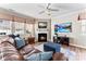 Inviting living room featuring a fireplace, ceiling fan, and comfortable leather seating at 12124 Red Rust Ln, Charlotte, NC 28277