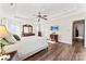 Bright and airy main bedroom with hardwood floors, tray ceilings, and TV at 12124 Red Rust Ln, Charlotte, NC 28277