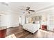 Spacious main bedroom with hardwood floors, tray ceiling, and a sitting area at 12124 Red Rust Ln, Charlotte, NC 28277