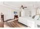 Well-lit main bedroom with tray ceiling, hardwood floors and en suite bathroom at 12124 Red Rust Ln, Charlotte, NC 28277