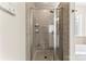 Tile shower with glass door and built-in shelves in the bathroom at 12124 Red Rust Ln, Charlotte, NC 28277