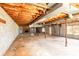 Unfinished basement featuring concrete walls, a fireplace, and wood ceiling supports at 126 Regal Cir # 2122, Mooresville, NC 28115