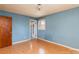 Simple bedroom featuring hardwood floors, blue walls, and an entryway to another room at 126 Regal Cir # 2122, Mooresville, NC 28115