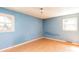 Empty bedroom featuring light-blue painted walls and hardwood floors at 126 Regal Cir # 2122, Mooresville, NC 28115