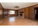 Inviting living room with wood-paneled walls, brick fireplace, and ample natural light at 126 Regal Cir # 2122, Mooresville, NC 28115