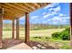 Covered patio overlooking a scenic yard with mature trees, providing a serene outdoor living space, relaxing views at 1316 Valhalla Dr, Denver, NC 28037