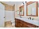 Detailed primary bathroom with a double vanity, tile floors, and a shower-tub combo, showcasing design and functionality at 1316 Valhalla Dr, Denver, NC 28037