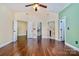 Spacious bedroom featuring hardwood floors and multiple doorways leading to en-suite baths and closets at 1316 Valhalla Dr, Denver, NC 28037