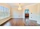 Bright dining room with hardwood floors, large window, elegant chandelier, and an open floorplan at 1316 Valhalla Dr, Denver, NC 28037