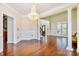 Bright dining room with hardwood floors, elegant chandelier, and architectural columns at 1316 Valhalla Dr, Denver, NC 28037