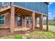 Brick home with a covered patio, showcasing a well-maintained exterior and access to outdoor living space at 1316 Valhalla Dr, Denver, NC 28037