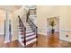 Elegant foyer with hardwood floors, staircase with iron railings, and bright natural light at 1316 Valhalla Dr, Denver, NC 28037
