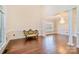 Bright living room with hardwood floors, large window, architectural columns, and chandelier at 1316 Valhalla Dr, Denver, NC 28037
