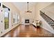 Large, bright living room features hardwood floors, fireplace, lots of windows, and staircase at 1316 Valhalla Dr, Denver, NC 28037