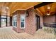 Enclosed brick patio with ceiling fan features outdoor seating, wooden floors, and brick design for comfortable outdoor living at 1316 Valhalla Dr, Denver, NC 28037