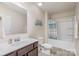Bathroom featuring a white shower and bathtub combo with light-toned walls and a white toilet at 1512 Brooksland Pl, Waxhaw, NC 28173