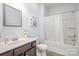 Bathroom with single vanity, framed mirror, and shower over tub with white shower curtain at 1512 Brooksland Pl, Waxhaw, NC 28173