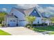 Exterior showcasing a three car garage, craftsman accents, and well maintained landscaping at 1512 Brooksland Pl, Waxhaw, NC 28173