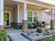 Inviting front porch with stone pillars and seating, offers a cozy outdoor space, and enhances curb appeal at 1512 Brooksland Pl, Waxhaw, NC 28173