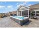 Backyard featuring a luxurious hot tub with a covered patio and residential neighborhood in the background at 1512 Brooksland Pl, Waxhaw, NC 28173