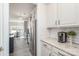 Bright kitchen with white cabinets, stainless steel appliances, granite countertops and modern backsplash, offering clean sightlines at 1512 Brooksland Pl, Waxhaw, NC 28173