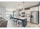 Modern kitchen with a large island, stainless steel appliances, white cabinets, and stylish pendant lighting at 1512 Brooksland Pl, Waxhaw, NC 28173