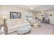 Living room with sofa, side chair, ottoman, end tables, artwork, and lamps at 1512 Brooksland Pl, Waxhaw, NC 28173