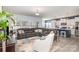 Open-concept living area showcases a modern design, featuring a large sectional sofa and seamlessly connecting to the kitchen at 1512 Brooksland Pl, Waxhaw, NC 28173