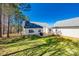 Green backyard with a deck, trees, and an outdoor grill at 155 Gray Cliff Dr, Mooresville, NC 28117