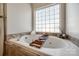 This bathroom features a soaking tub with a small ledge and a tiled backsplash at 155 Gray Cliff Dr, Mooresville, NC 28117