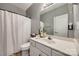 This bathroom has a white vanity, mirror, and a shower with a white curtain at 155 Gray Cliff Dr, Mooresville, NC 28117