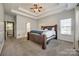 This bedroom has a tray ceiling with ceiling fan and a brown wood bed frame with blue pillows and bedding at 155 Gray Cliff Dr, Mooresville, NC 28117