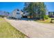 Long driveway leading to a two-story home with an attached garage surrounded by mature trees and landscaping at 155 Gray Cliff Dr, Mooresville, NC 28117