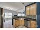 Spacious kitchen featuring light wood cabinets, stainless steel appliances, and a view into an adjacent living area at 155 Gray Cliff Dr, Mooresville, NC 28117