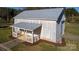 Aerial view of metal building featuring a covered porch, metal roof, and landscaping at 1615 Stack Rd, Monroe, NC 28112