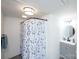 Bathroom featuring a shower with patterned curtain and a vanity with a round mirror at 1615 Stack Rd, Monroe, NC 28112