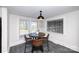 Charming breakfast nook featuring a round table, modern lighting, and natural light from three windows at 1615 Stack Rd, Monroe, NC 28112