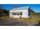 Exterior view of metal building with covered porch, green grass, and concrete walkway at 1615 Stack Rd, Monroe, NC 28112