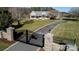 Long driveway leads to a charming country estate with stone gateposts, wrought iron gates, and an American flag at 1615 Stack Rd, Monroe, NC 28112