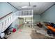 Spacious garage with staircase, kayak and ample room for vehicles and storage at 1615 Stack Rd, Monroe, NC 28112