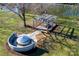 Aerial view of a backyard with a hot tub, pergola, and lush greenery, perfect for outdoor relaxation and entertainment at 1615 Stack Rd, Monroe, NC 28112