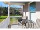 Inviting porch featuring comfortable wicker chairs and a table, with a serene view of the lake and lush greenery at 1615 Stack Rd, Monroe, NC 28112